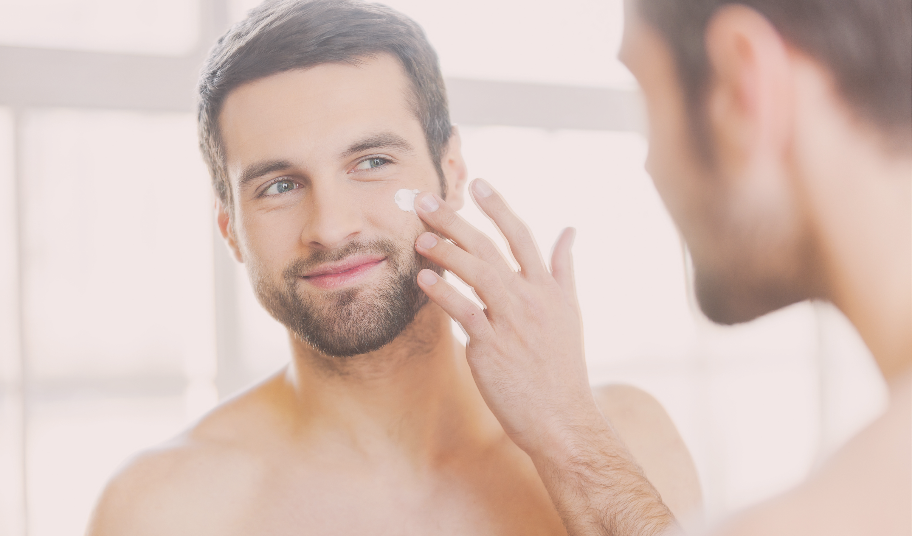 man applying natural skincare to face