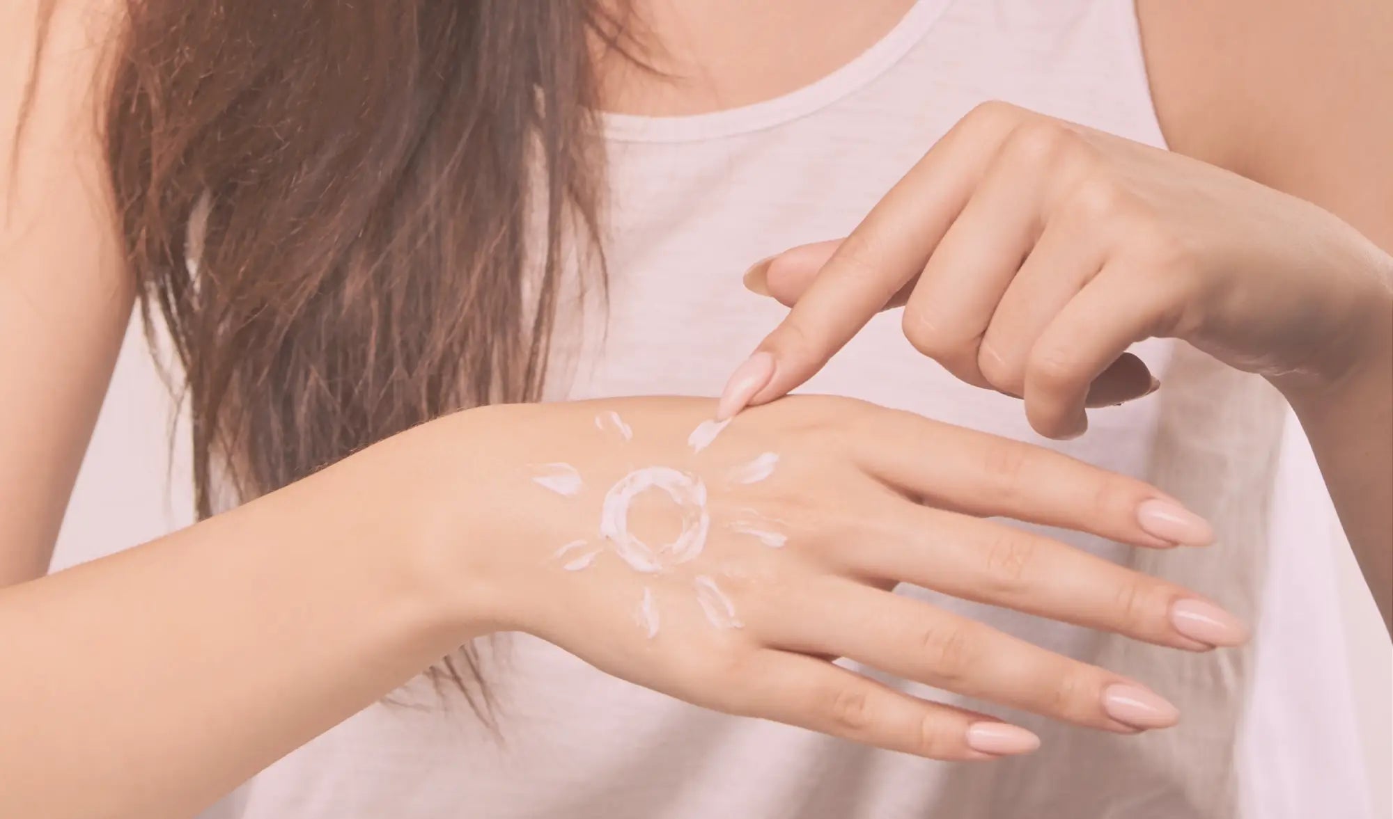 sunscreen on hand in pattern of a sun