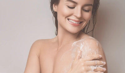 woman applying body wash to body