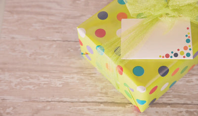gift with polka dot wrapping and green bow