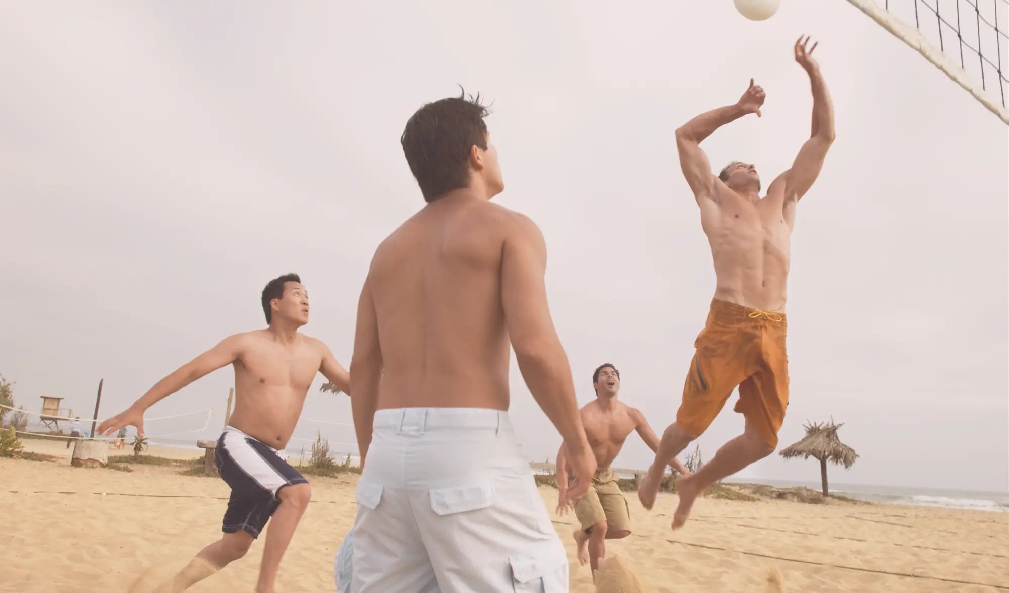 men playing beach volleyball