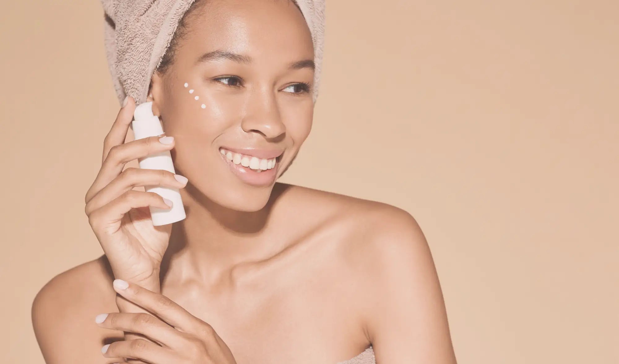 woman applying a natural moisturiser to her cheeks