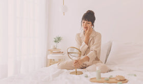 Woman practicing self care but applying skincare to face