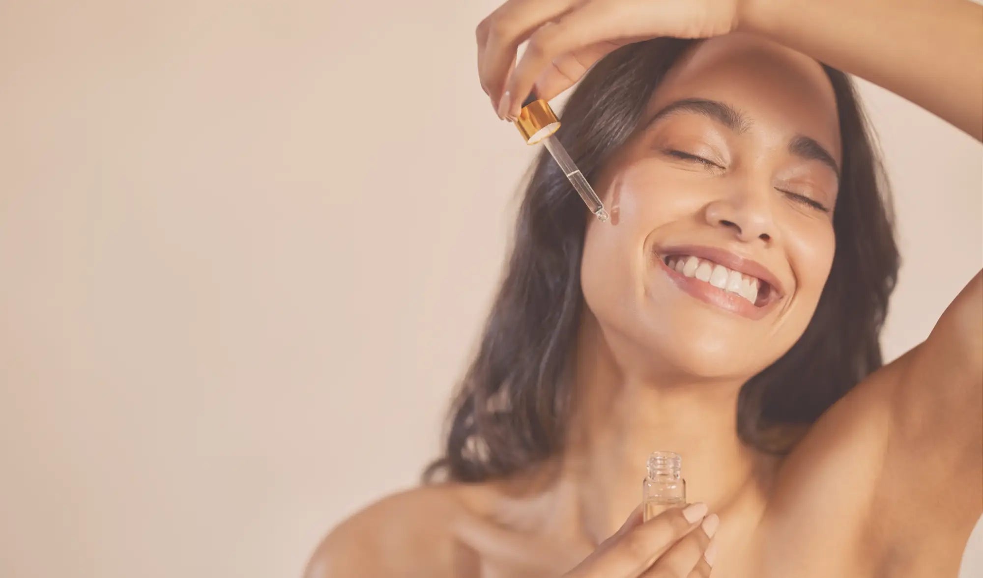 Woman applying serum to face with dropper