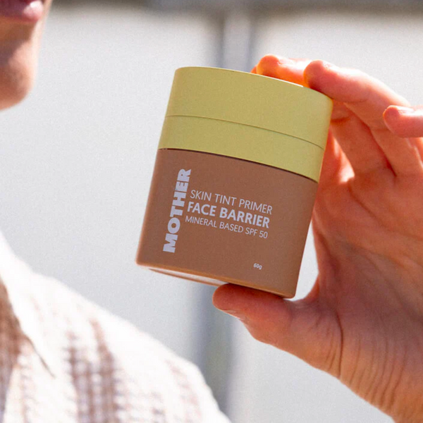 Mother SPF Face Barrier SPF 50 in women's hands.