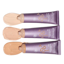 Three purple tubes of foundation or BB cream with beige product swatches beside them.