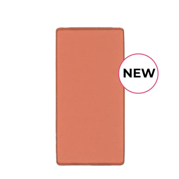 Rectangular peach-colored cosmetic product with a ’NEW’ label.
