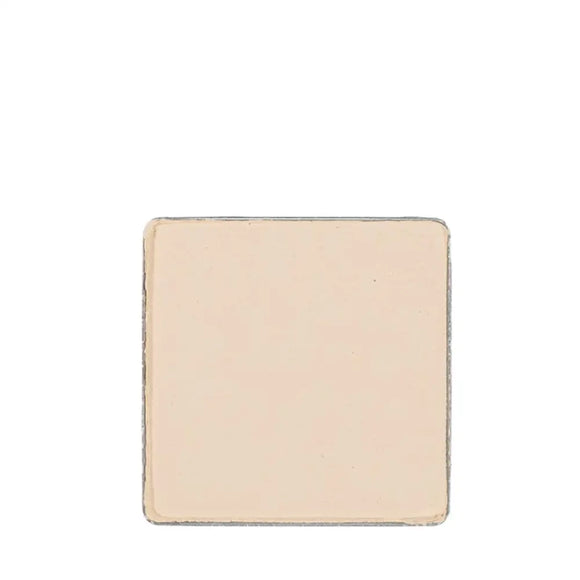 Square-shaped beige or cream-colored tile or ceramic piece with slightly rough edges.
