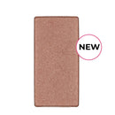 Rectangular pan of shimmery bronze-colored eyeshadow or highlighter makeup product.