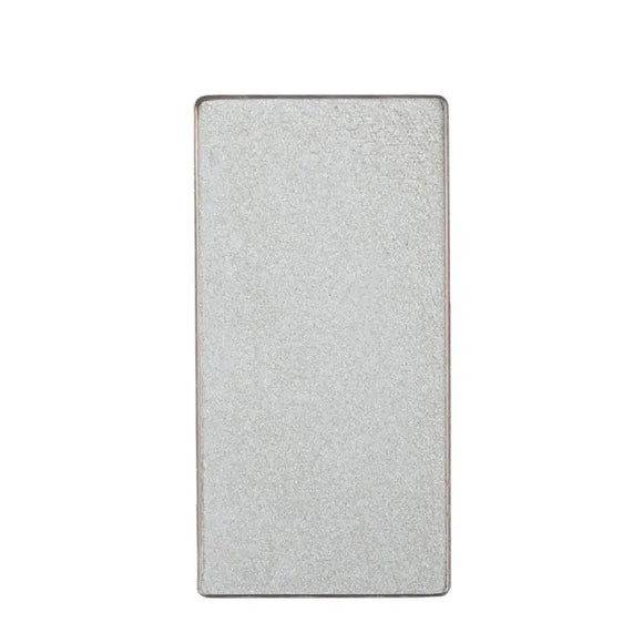 Rectangular silver-colored eyeshadow or makeup pan with a shimmery finish.