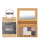 Eyeshadow palette with neutral and purple shades in cardboard packaging labeled ’Beauty ID New York.’