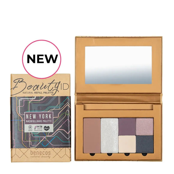 Eyeshadow palette with neutral and purple shades in cardboard packaging labeled ’Beauty ID New York.’