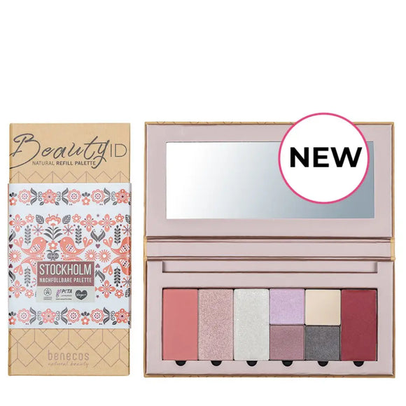 Makeup palette with multiple eyeshadow and blush colors in a pink case with a mirror.