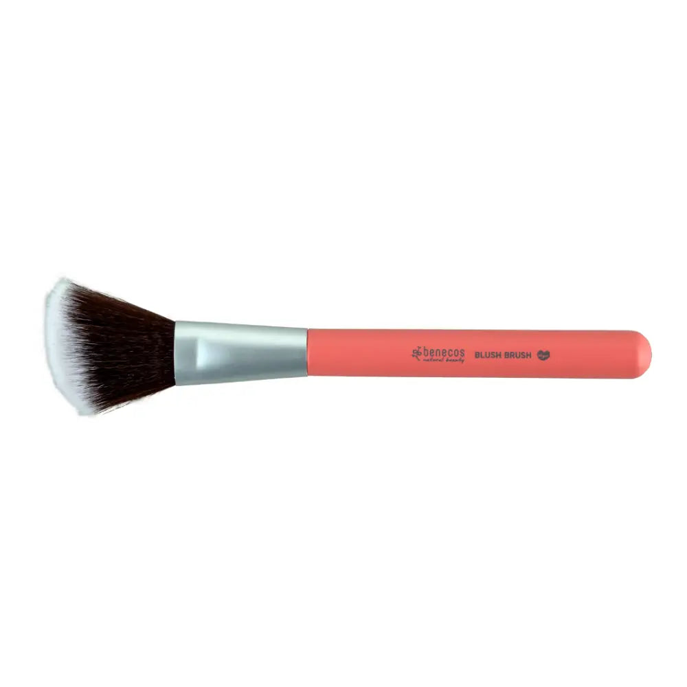 Coral-colored makeup brush with black bristles and a silver ferrule.