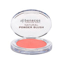Coral-colored natural powder blush in a clear compact case with ’benecos’ branding.