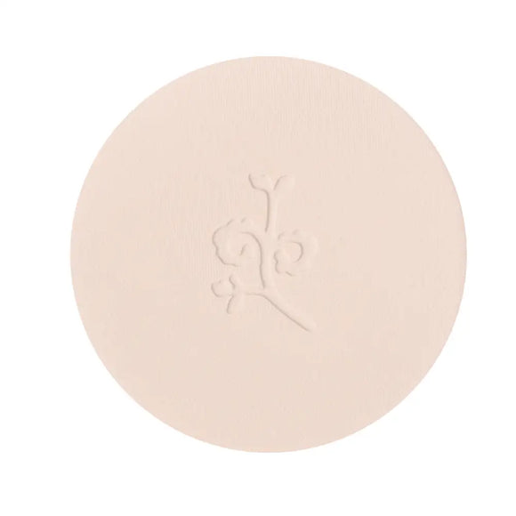 Circular beige pressed powder compact with an embossed design.