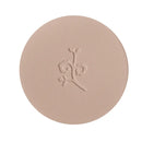 Circular pressed powder compact with an embossed floral design.
