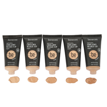 Five tubes of vegan foundation with color swatches.