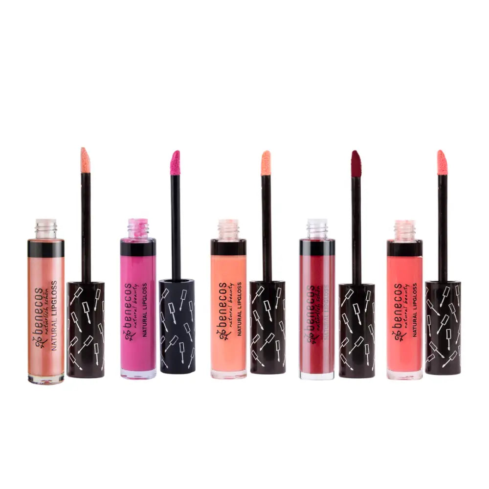 Collection of liquid lipsticks in various pink and coral shades with black marble-patterned packaging.