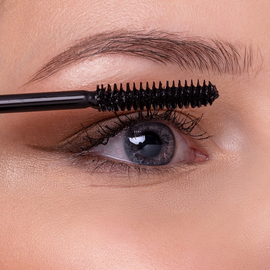Mascara wand applying makeup.