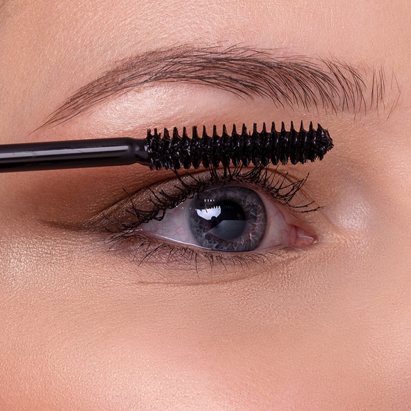 Mascara wand applying makeup.