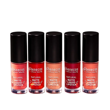 Five bottles of pink and red Benecos natural liquid lipstick arranged in a row.
