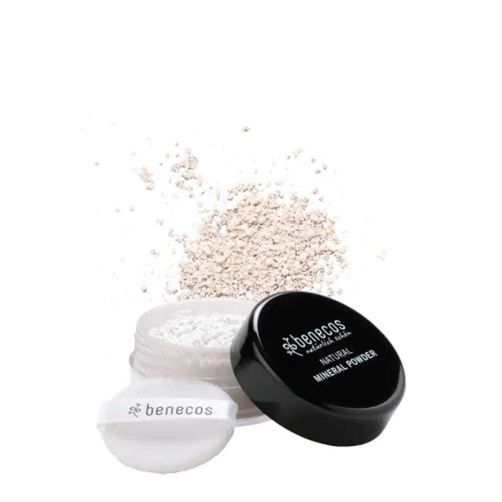 Loose mineral powder with a black lid and white powder puff.