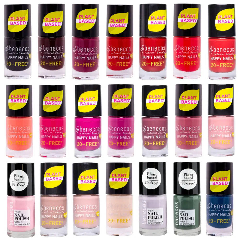 Collection of nail polish bottles in various shades of pink, red, nude, and gray.