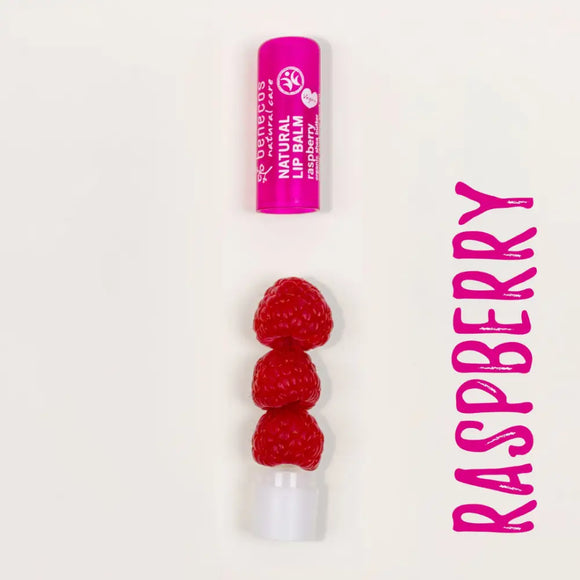 Three fresh red raspberries stacked vertically on a white base with a pink lip balm tube above.