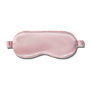 A smooth, light pink silk sleep mask with elastic straps.