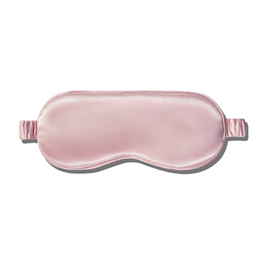 A smooth, light pink silk sleep mask with elastic straps.