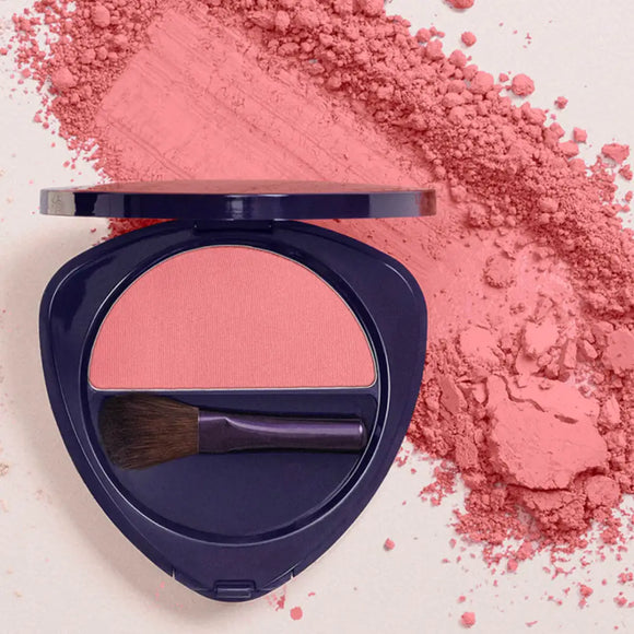 Navy blue compact powder case containing pink blush with a makeup brush.