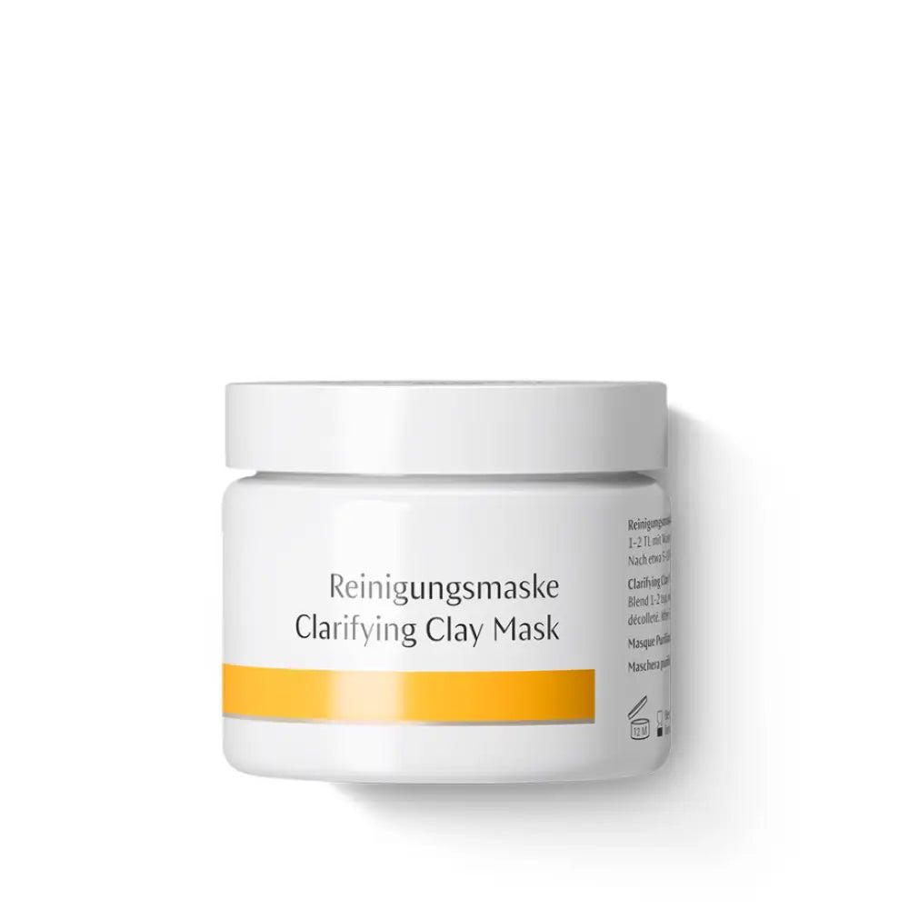 White jar of Dr. Hauschka Clarifying Clay Mask with yellow accent stripe.