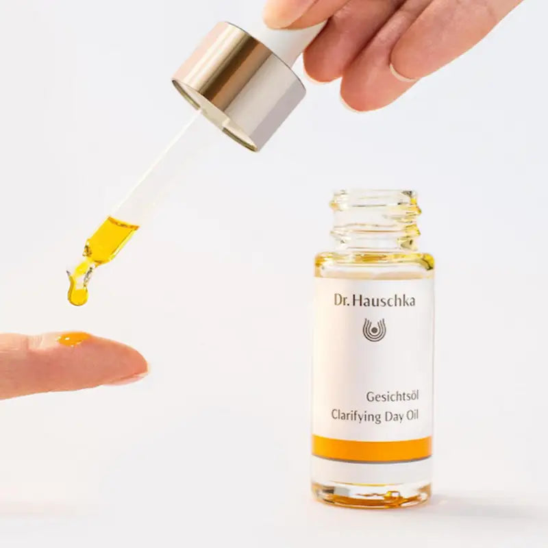 Dr. Hauschka Clarifying Day Oil in a glass bottle with a gold-toned cap.