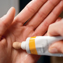 Hand sanitizer or liquid soap being dispensed onto a palm.