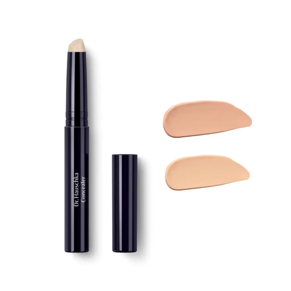 Black twist-up concealer stick with two beige swatches beside it.