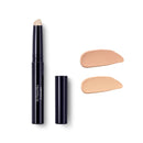 Black twist-up concealer stick with two beige swatches beside it.