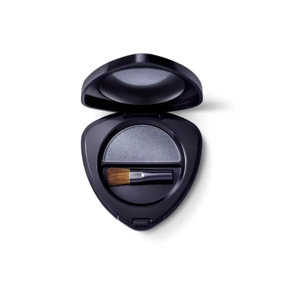 Black triangular compact case containing eyeshadow and a small brush.