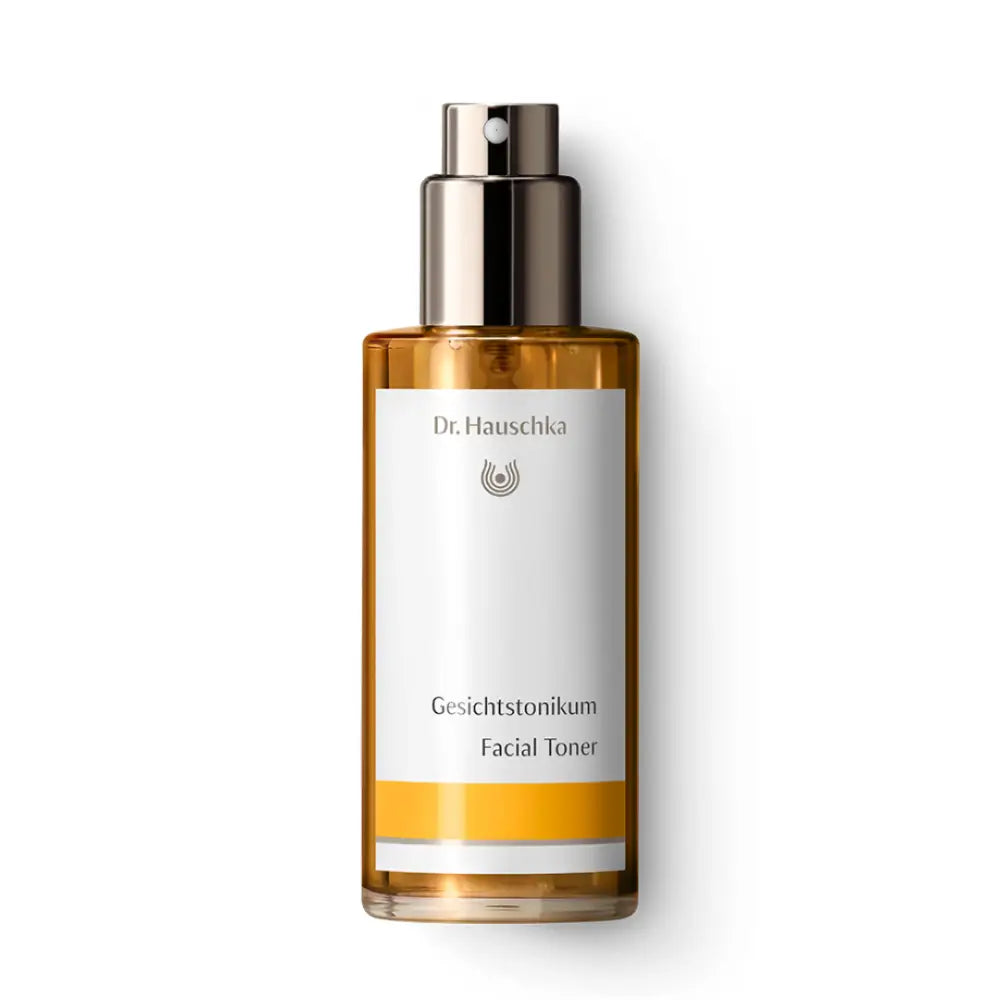 Glass bottle of Dr. Hauschka facial toner with a silver pump dispenser top.