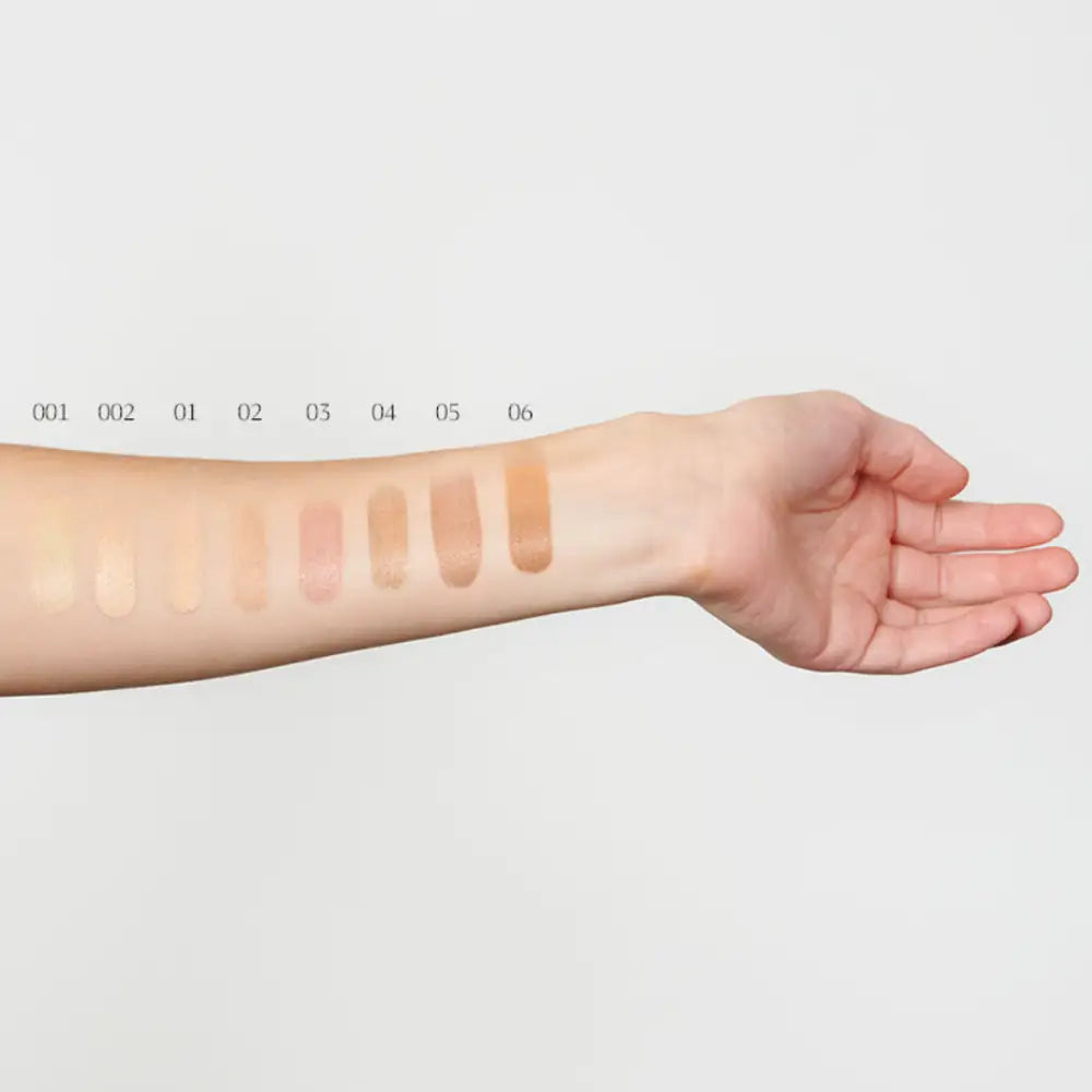 Makeup foundation swatches displayed on an inner forearm.