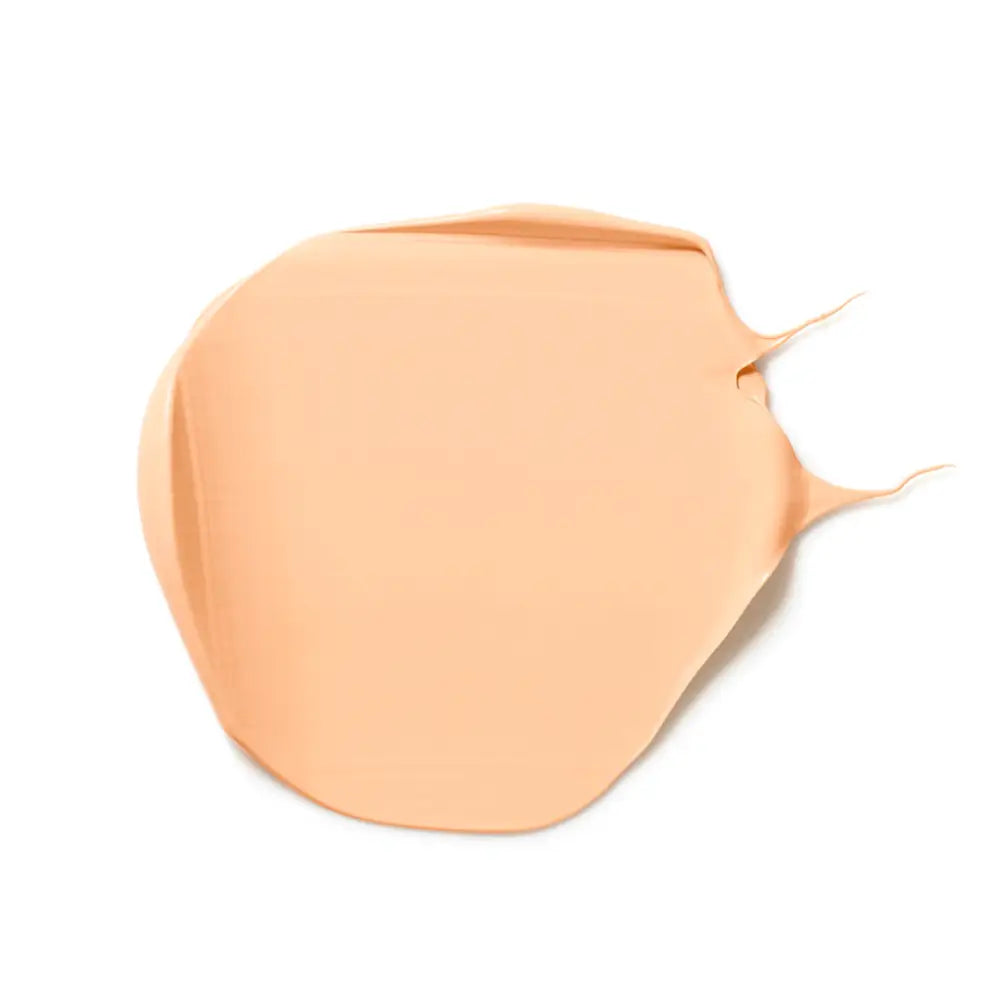 Peach-colored liquid foundation smear with a smooth texture.