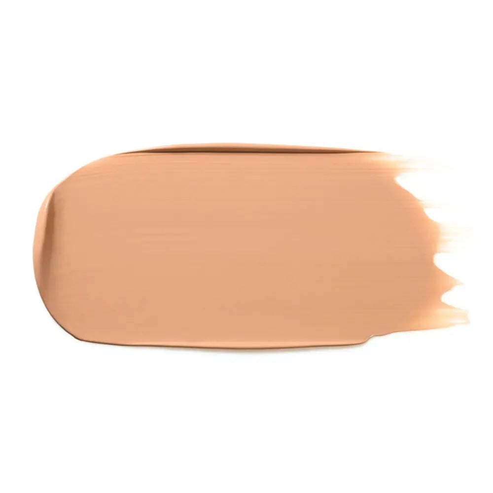 Peach-colored makeup foundation smear with a smooth texture.