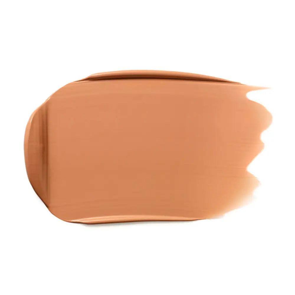 Peach-toned liquid foundation or concealer smear with a soft, blended edge.