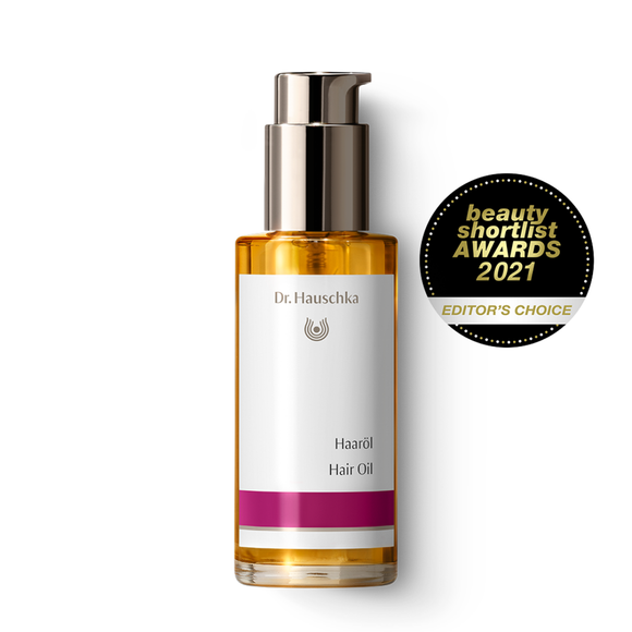 Bottle of hair oil with pump.