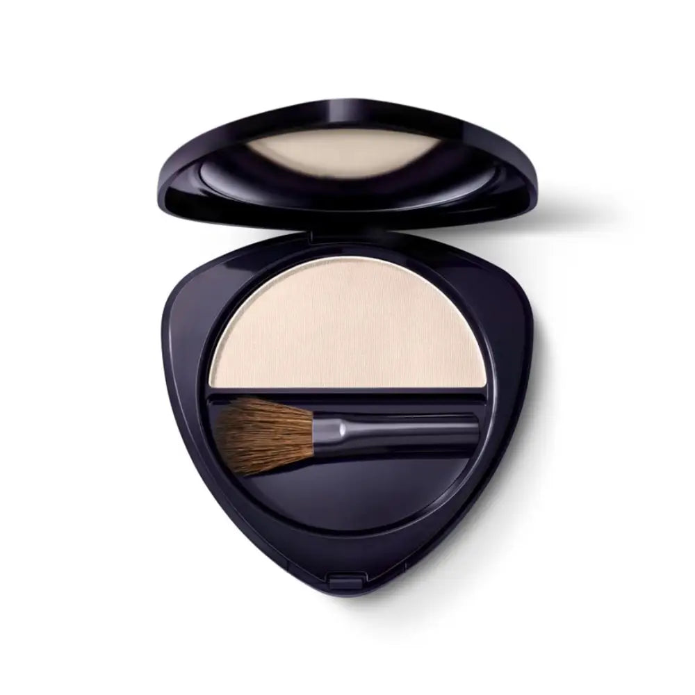 Black compact powder case with a brush and light-colored pressed powder inside.