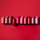 Row of lipsticks in various shades of pink and red.
