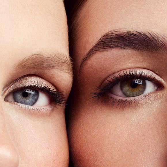 Close-up of two women’s eyes, one with blue irises and the other with hazel irises.