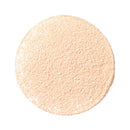 Circular disc of light peachy-beige powder with a finely textured surface.