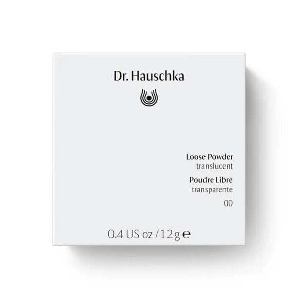 White Dr. Hauschka loose powder container with black text.