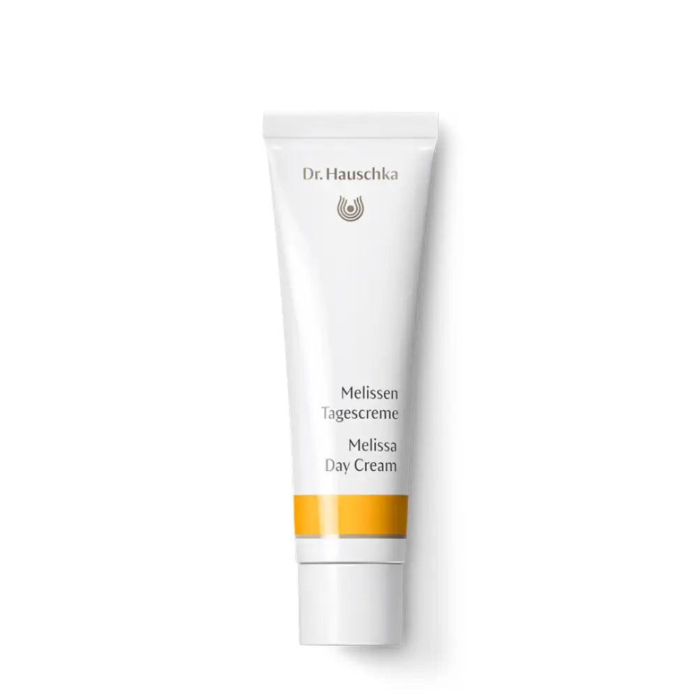 White tube of Dr. Hauschka Melissa Day Cream with an orange stripe.